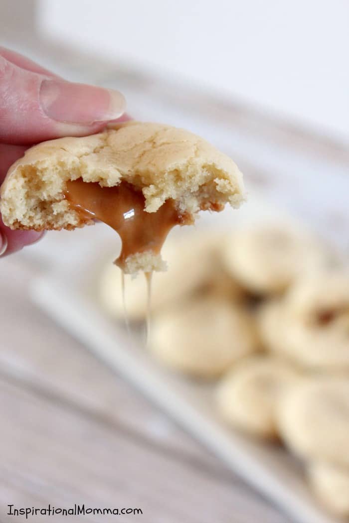 These Caramel Filled Sugar Cookies will melt in your mouth and blow your mind. The smooth caramel is the perfect surprise inside a soft, chewy cookie!