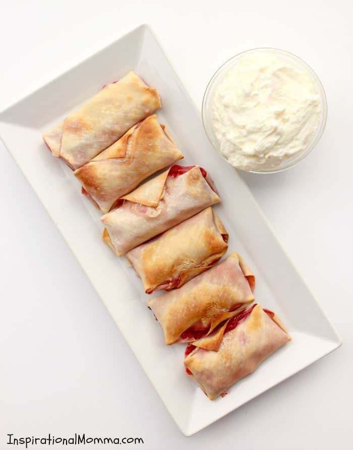 Sweet strawberries wrapped in a crispy, baked egg roll and topped with homemade whipped cream! This is a simple, decadent dessert that is sure to impress!