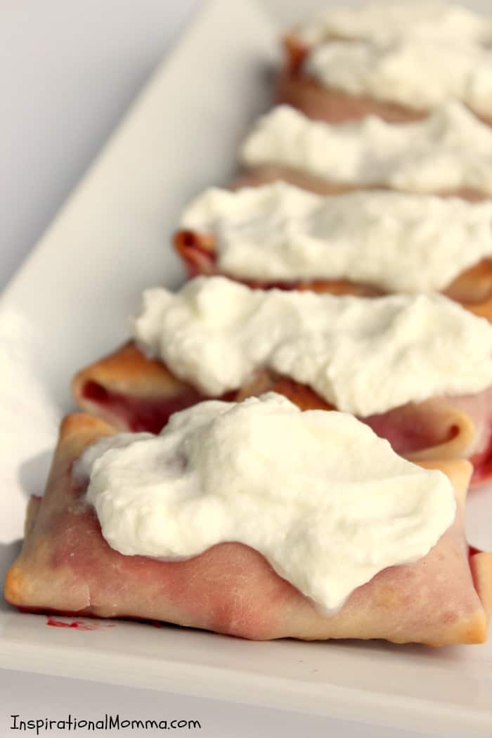 Sweet strawberries wrapped in a crispy, baked egg roll and topped with homemade whipped cream! This is a simple, decadent dessert that is sure to impress!