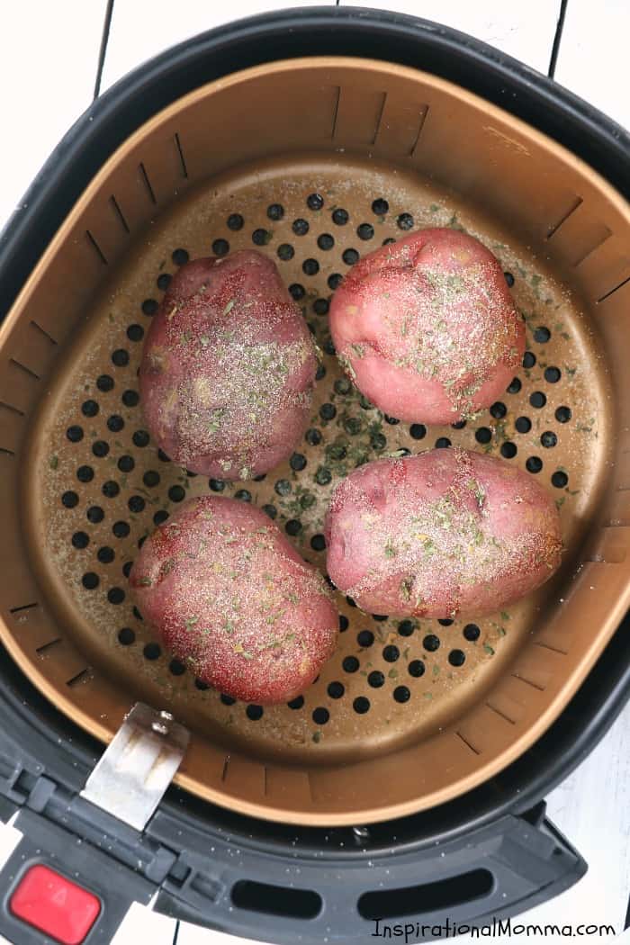 Easy Air Fryer Baked Potatoes are drizzled with olive oil and sensationally seasoned. Cooked to perfection in your Air Fryer, you will make them again and again! #InspirationalMomma #AirFryer #bakedpotatoes #potatoes #baked #quick #easy 