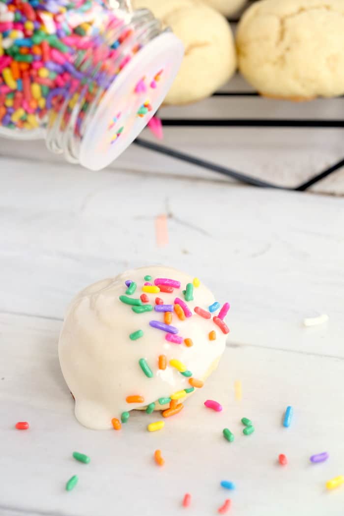 Soft Chewy Confetti Cookies are light, delicious and melt in your mouth. Covered with sweet icing and sprinkles, they are absolutely irresistible! #inspirationalmomma #confetticookies #cookies #softandchewy #recipe #dessert #desserts #cookie