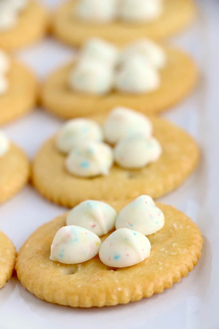 Spring Flower Ritz Cracker Recipe - Crispy Ritz Crackers covered with melted confetti white chocolate chips, and finally topped off with a gorgeous M&M flower. #inspirationalmomma #springtreats #springdesserts #eastertreats #easterdesserts #ritzcracker #m&ms #easydessert #quick #recipe #ritzcrackerrecipes