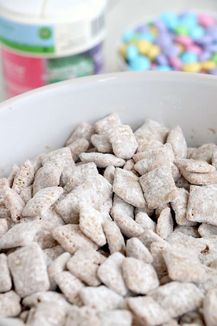 This Spring Puppy Chow Recipe is finger-food at its finest! Chex cereal covered in chocolate, peanut butter, and powdered sugar is a delicious combination! #inspirationalmomma #puppychowrecipe #puppychow #spring #easter #dessert #desserts #chex #peanutbutter #chocolate
