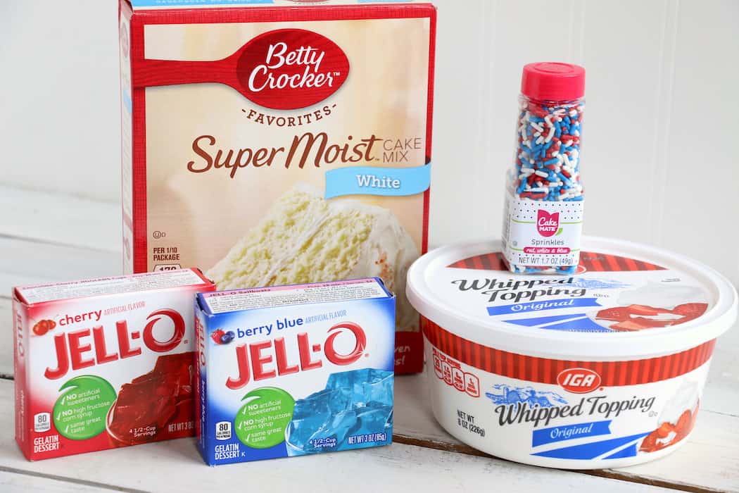 Show your American pride with this Patriotic Jello Poke Cake! Moist, delicious cake drizzled with sweet, colorful jello, all covered with whipped topping! #InspirationalMomma #jellopokecake #pokecake #America #4thofJuly #jello #cake #dessert #desserts #recipe #patriotic #redwhiteblue
