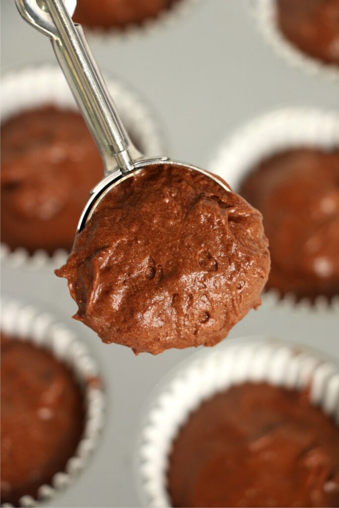 Closeup overhead shot of scoopful of chocolate cupcake batter