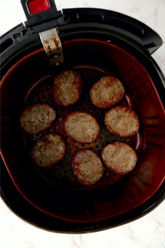 Overhead shot of cooked air fryer frozen sausage patties in air fryer