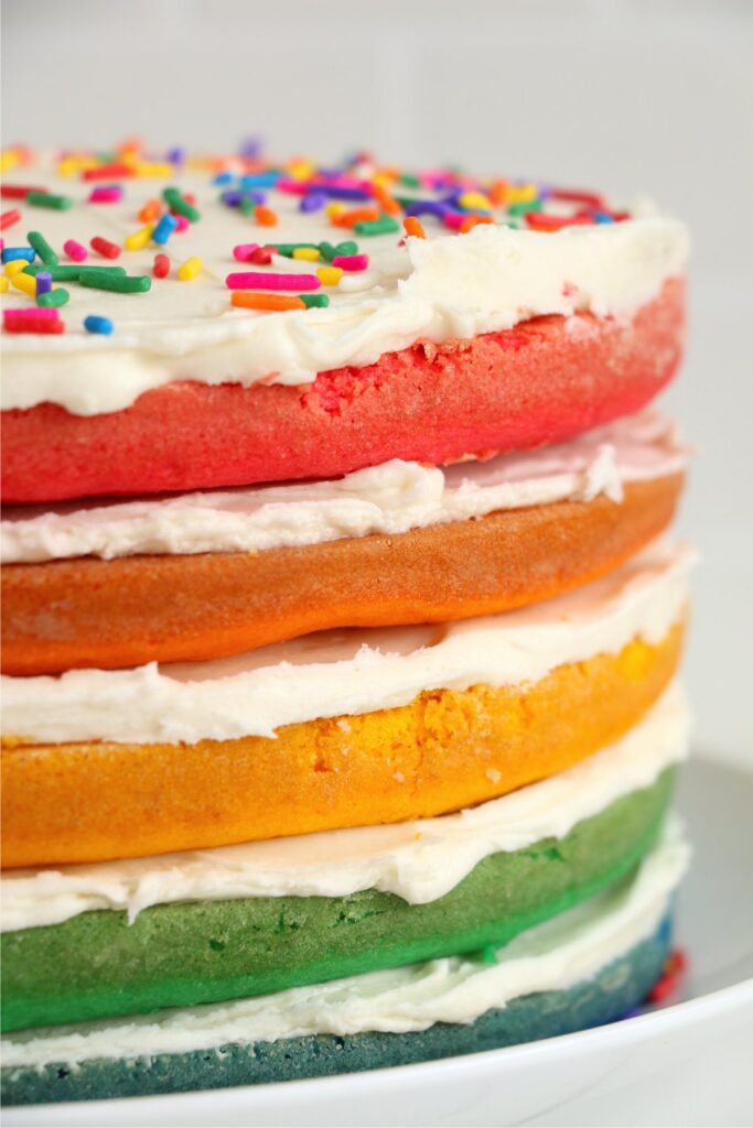Naked rainbow cake on plate