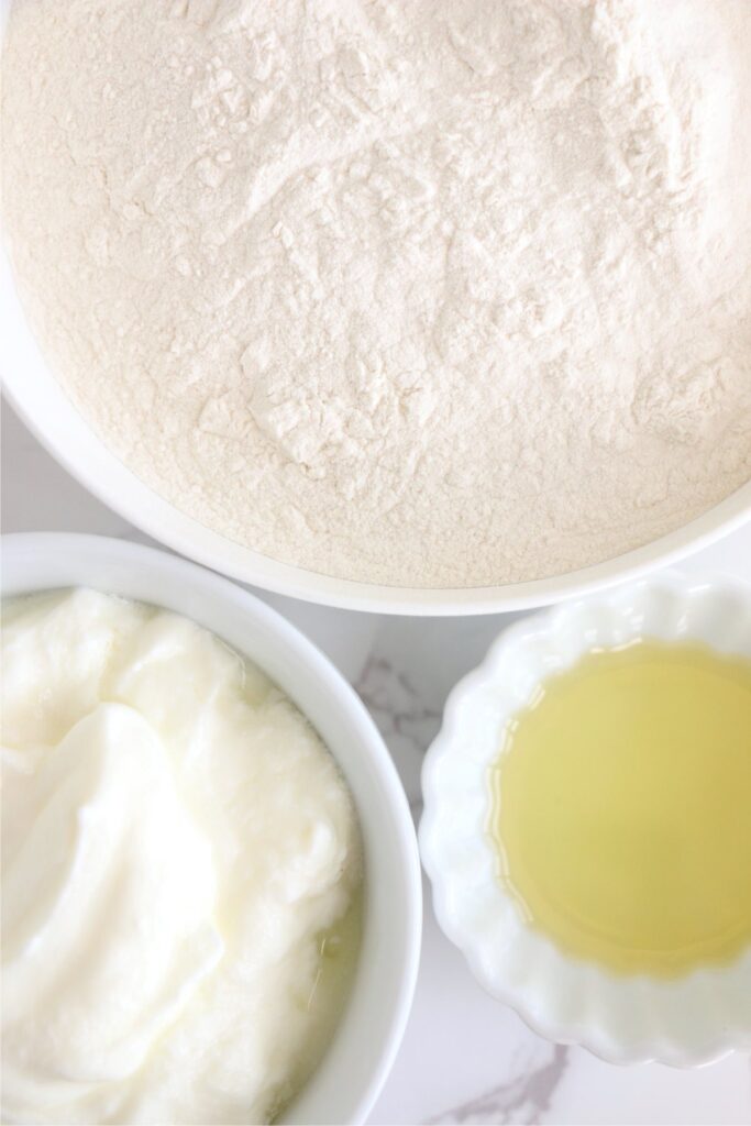 Closeup overhead shot of individual flatbread ingredients in bowls