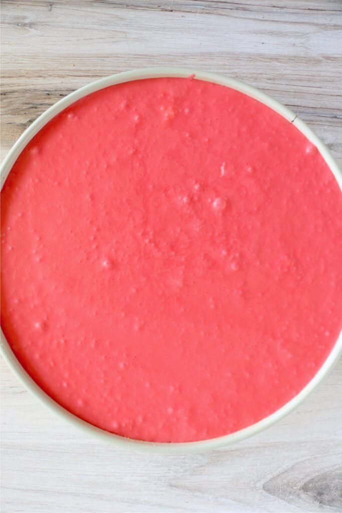 Overhead shot of cheesecake with Jello mixture on top in springform pan
