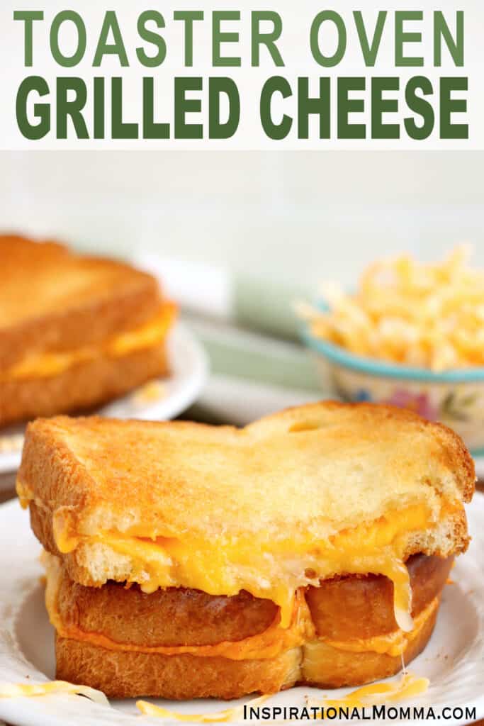 Closeup shot of two halves of toaster oven grilled cheese stacked atop one another on plate