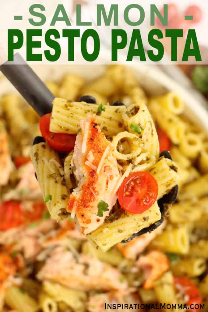 Closeup overhead shot of serving spoon full of salmon and pesto pasta. 